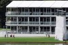 Golfers putt on the 15th green below a three story corporate suite during practice for the Tour Championship golf tournament in Atlanta, Wednesday, Aug. 21, 2019. (Curtis Compton/Atlanta Journal-Constitution via AP)