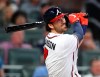 Atlanta Braves shortstop Dansby Swanson hits a solo home run against the Chicago Cubs during the third inning of a baseball game, Wednesday, April 3, 2019 in Atlanta. (Curtis Compton/Atlanta Journal-Constitution via AP)