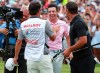 Rory McIlroy celebrates with his caddy Harry Diamond with Brooks Koepka looking on after making his birdie putt to win the Tour Championship golf tournament and The FedEx Cup Sunday, Aug. 25, 2019, at East Lake Golf Club in Atlanta. (Curtis Compton/Atlanta Journal-Constitution via AP)