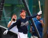 FILE - In this Feb. 21, 2019, file photo, Atlanta Braves third baseman Josh Donaldson smiles while watching the ball leave the park during batting practice at the team's spring training baseball facility in Kissimmee, Fla. (Curtis Compton/Atlanta Journal-Constitution via AP, File)