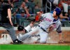 Atlanta Braves catcher Brian McCann tags out New York Mets' Todd Frazier at the plate on a throw from Ronald Acuna Jr. during the sixth inning of a baseball game Tuesday, Aug. 13, 2019, in Atlanta. (Curtis Compton/Atlanta Journal-Constitution via AP)