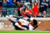 Atlanta Braves second baseman Ozzie Albies (1) slides safely into home plate under the tag of Chicago White Sox catcher Welington Castillo (21) during the first inning of a baseball game, Saturday, Aug. 31, 2019, in Atlanta, Ala. (AP Photo/Butch Dill)