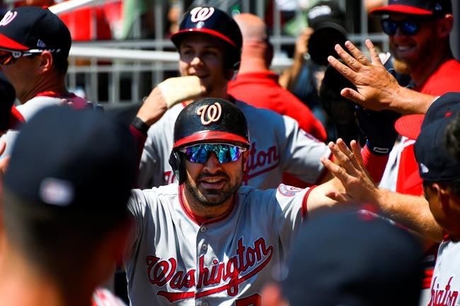 Washington Nationals' Adam Eaton is congratulated in the dugout followed by Trea Turner after hitting a two-run home run during the first inning of a baseball game against the Atlanta Braves, Sunday, Sept. 8, 2019, in Atlanta. (AP Photo/John Amis)