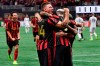 Atlanta United defender Julian Gressel (24) celebrates a goal by defender Franco Escobar, right, during the second half of round one of an MLS Cup playoff soccer game against the New England Revolution, Saturday, Oct. 19, 2019, in Atlanta. Atlanta United won 1-0. (AP Photo/John Amis)