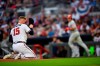 Atlanta Braves pitcher Sean Newcomb (15) goes to his knees after being hit in the head with a line drive by Philadelphia Phillies' J.T. Realmuto, right, as Realmuto makes his way to base on a ground-rule double and injury delay during the third inning of a baseball game Saturday, June 15, 2019, in Atlanta. Newcombe came out of the game. (AP Photo/John Amis)