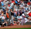 Philadelphia Phillies pitcher Cole Irvin, foreground, smoothes the mound as Atlanta Braves' Josh Donaldson, back right, runs bases after hitting a two-run home run in the third inning of a baseball game Sunday, June 16, 2019, in Atlanta. (AP Photo/John Amis)