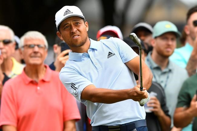 Xander Schauffele hits to the fifth green during the final round of the Tour Championship golf tournament Sunday, Aug. 25, 2019, in Atlanta. (AP Photo/John Amis)