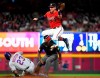New York Mets' Keon Broxton (23) steals second base as Atlanta Braves shortstop Dansby Swanson goes high for the throw from catcher Tyler Flowers during the fourth inning of a baseball game Friday, April 12, 2019, in Atlanta. (AP Photo/John Amis)