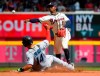 Atlanta Braves second baseman Ozzie Albies throws to first after forcing out Miami Marlins' Martin Prado, and gets Starlin Castro at first base during the eighth inning of a baseball game Sunday, April 7, 2019, in Atlanta. (AP Photo/John Amis)