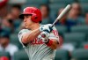 Philadelphia Phillies' J.T. Realmuto drives in a run with a base hit during the first inning of the team's baseball game against the Atlanta Braves on Thursday, July 4, 2019, in Atlanta. (AP Photo/John Bazemore)