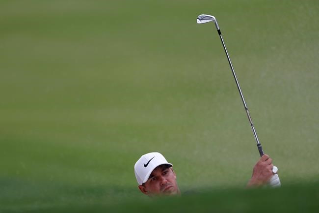 Brooks Koepka hits from a fairway bunker on the 13th hole during third-round play in the Tour Championship golf tournament Sunday, Aug. 25, 2019, at East Lake Golf Club in Atlanta. (AP Photo/John Bazemore)