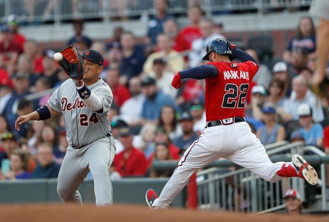 Atlanta Braves' Nick Markakis (22) is out at first base by Detroit Tigers first baseman Miguel Cabrera (24) after hitting a ground ball in the first inning of a baseball game Friday, May 31, 2019, in Atlanta. (AP Photo/John Bazemore)