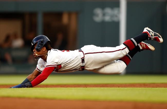 Atlanta Braves' Ronald Acuna Jr. (13) dives head first as he steals second base in the third inning of a baseball game against the St. Louis Cardinals Wednesday, May 15, 2019, in Atlanta. (AP Photo/John Bazemore)