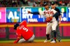 Atlanta Braves second baseman Ozzie Albies (1) throws to first to complete the double play after forcing out Washington Nationals' Brian Dozier (9) on a Kurt Suzuki ground ball in the fourth inning of a baseball game Saturday, July 20, 2019, in Atlanta. (AP Photo/John Bazemore)