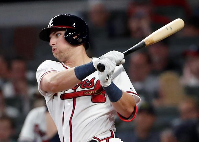 CORRECTS TO FIFTH INNING, INSTEAD OF SIXTH - Atlanta Braves' rookie Austin Riley follows through on a base hit in the fifth inning of the team's baseball game against the St. Louis Cardinals on Thursday, May 16, 2019, in Atlanta. (AP Photo/John Bazemore)