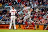 Washington Nationals starting pitcher Stephen Strasburg (37) runs past Atlanta Braves first baseman Freddie Freeman (5) as he runs the bases after hitting a two-run home run during the third inning of a baseball game Thursday, July 18, 2019, in Atlanta. (AP Photo/John Bazemore)