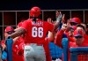 Philadelphia Phillies' Gift Ngoepe (66) celebrates at the dugout entrance after hitting a two-run home run in the seventh inning of a spring training baseball game against the Tampa Bay Rays Thursday, March 14, 2019, in Port Charlotte, Fla. Philadelphia won 4-3. (AP Photo/John Bazemore)