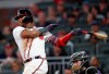 Atlanta Braves' Ronald Acuna Jr., left, drives in two runs with a base hit in the fifth inning of a baseball game against the Colorado Rockies, Saturday, April 27, 2019, in Atlanta. (AP Photo/John Bazemore)