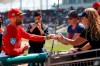 Boston Red Sox second baseman Dustin Pedroia (15) signs autographs for fans before the start a spring training baseball game against the Minnesota Twins, Thursday, March 7, 2019, in Fort Myers, Fla. (AP Photo/John Bazemore)