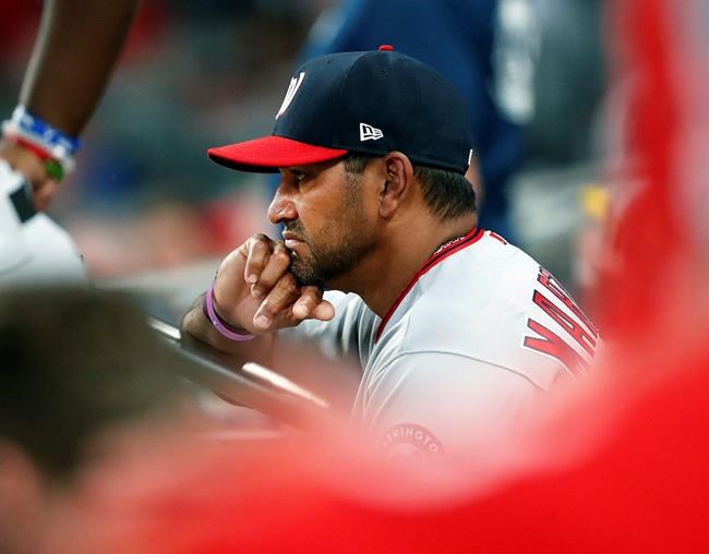 Washington Nationals manager Dave Martinez (4) looks on from the dugout during a baseball game against the Atlanta Braves, Tuesday, May 28, 2019, in Atlanta. Washington won 5-4. (AP Photo/John Bazemore)
