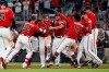 Atlanta Braves' Josh Donaldson, center, is mobbed by teammates after driving in the winning run with a base hit in the ninth inning of a baseball game against the Washington Nationals, Friday, July 19, 2019, in Atlanta. (AP Photo/John Bazemore)