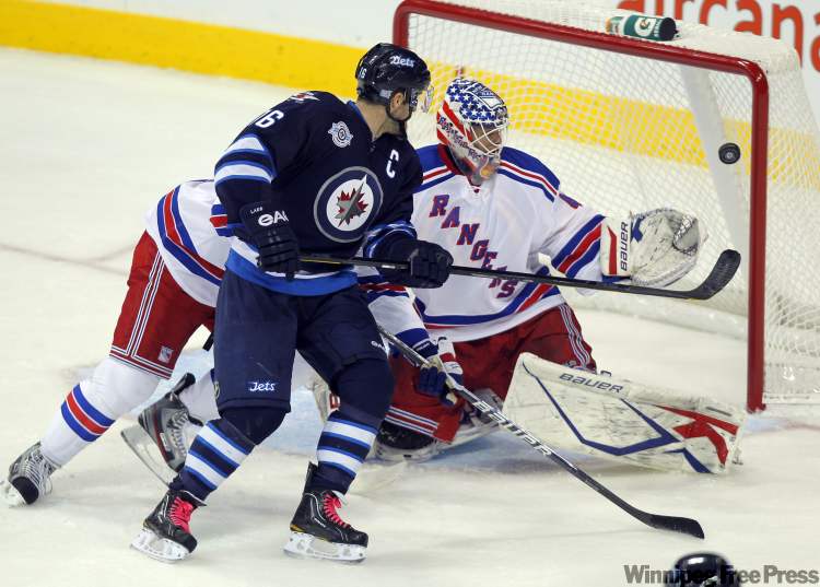 Boris Minkevich / Winnipeg Free Press
Jet Andrew Ladd tries to get it past Ranger goalie Martin Biron Monday at the MTS Centre.