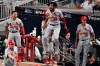 St. Louis Cardinals players celebrate St. Louis Cardinals Marcell Ozuna hit of a two RBI double in the ninth inning during Game 1 of a best-of-five National League Division Series against the Atlanta Braves, Thursday, Oct. 3, 2019, in Atlanta. (AP Photo/Scott Cunningham)