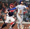 Kansas City Royals batter Alex Gordon watches his solo home run as Atlanta Braves catcher Tyler Flowers, left, looks on during the sixth inning of a baseball game Tuesday, July 23, 2019, in Atlanta. (AP Photo/Tami Chappell)