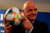 FIFA President Gianni Infantino holds the official ball of the upcoming Women's Soccer World Championship as he poses for photographers during a press conference at the end of an executive committee meeting in Rome, Wednesday, Feb. 27, 2019. (AP Photo/Gregorio Borgia)