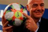 FIFA President Gianni Infantino holds the official ball of the upcoming Women's Soccer World Championship as he poses for photographers during a press conference at the end of an executive committee meeting in Rome, Wednesday, Feb. 27, 2019. (AP Photo/Gregorio Borgia)