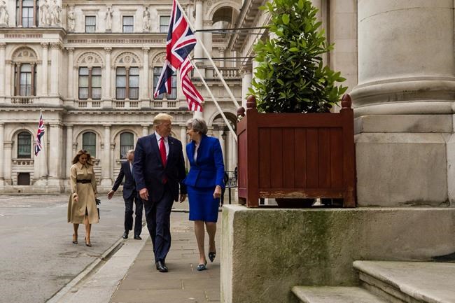 President Donald Trump walks with British Prime Minister Theresa May, followed by first lady Melania Trump, and Philip May, to a news conference at the Foreign Office, Tuesday, June 4, 2019, in central London. (AP Photo/Alex Brandon)