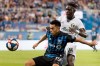 Montreal Impact's Mathieu Choiniere, left, and Portland Timbers' Modou Jadama move in on the ball during second half MLS soccer action in Montreal, Wednesday, June 26, 2019. THE CANADIAN PRESS/Graham Hughes