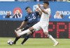 Montreal Impact's Saphir Taider, left, is challenged by New England Revolution's Juan Agudelo during second half MLS soccer action in Montreal, Saturday, May 18, 2019. THE CANADIAN PRESS/Graham Hughes