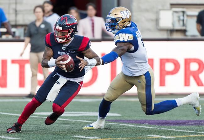 Montreal Alouettes quarterback Vernon Adams Jr., left, breaks away from Winnipeg Blue Bombers linebacker Adam Bighill during second half CFL football action in Montreal, Saturday, September 21, 2019. The CFL is reviewing the helmet-swinging incident Saturday involving Adams Jr. and Bighill.THE CANADIAN PRESS/Graham Hughes