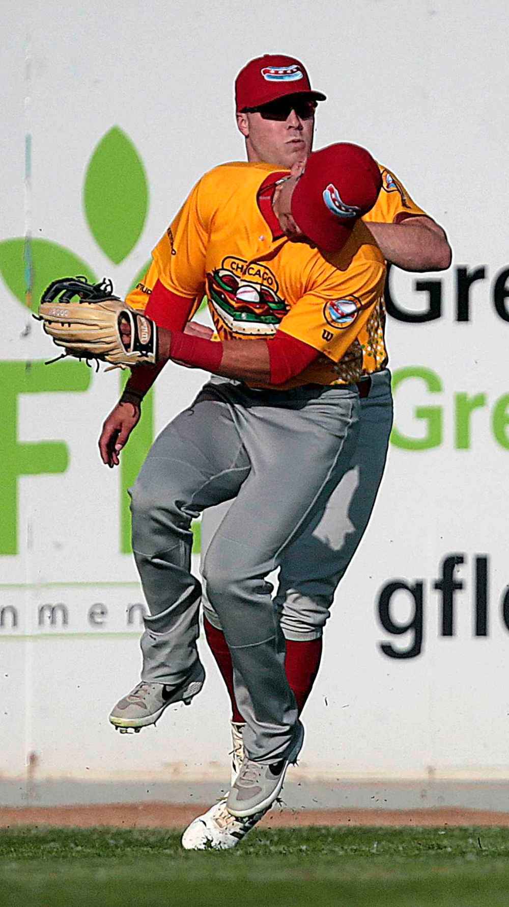 Chicago Dogs outfielders David Olmedo-Barrera (front) and Tony Rosselli collide fielding a pop fly in the first inning.