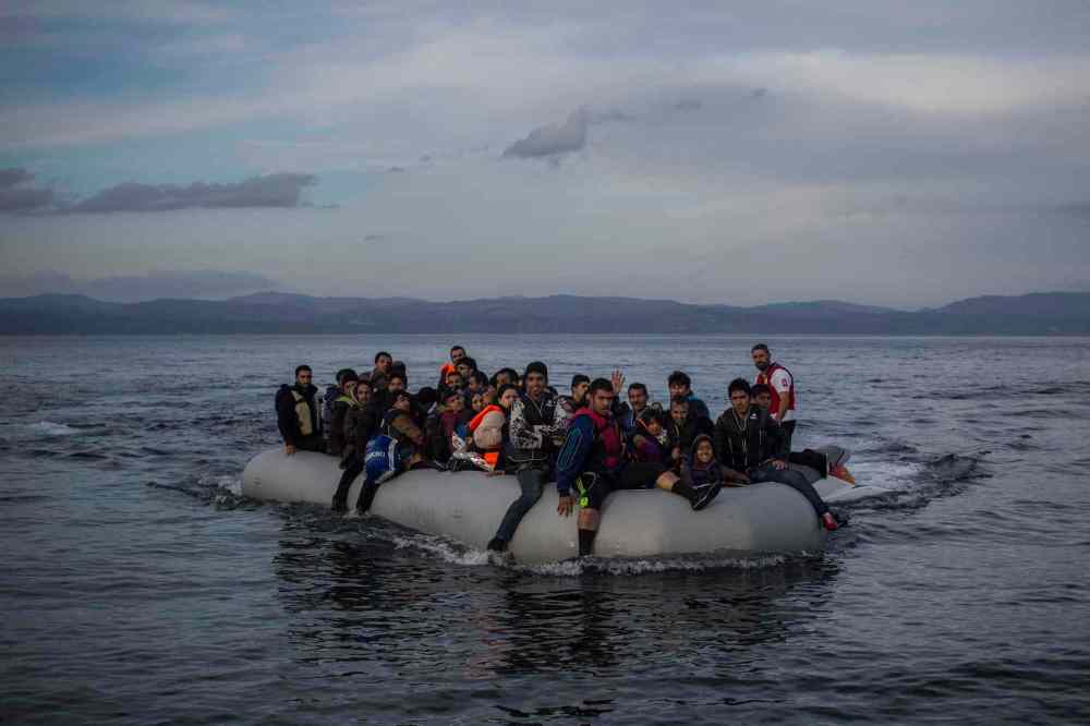 Santi Palacios / THe ASsociated Press
Refugees approach the coast of the northeastern Greek island of Lesbos on a dinghy, helped by a Spanish volunteer lifeguard, after crossing the Aegean from the Turkey's coast, on Tuesday, Nov. 24, 2015.