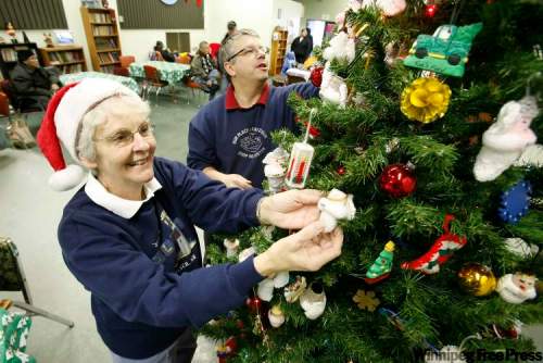 JOHN WOODS / WINNIPEG FREE PRESS
Jackie Gushuliak and Claude Lambert decorate the Our Place Chez Nous Christmas tree with six angels to commemorate six homeless people who died on the streets of Winnipeg this year.