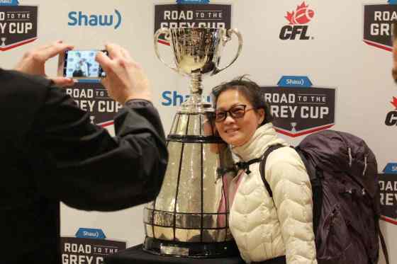 Jeff Hamilton / Winnipeg Free PressYannie Lin poses with the Grey Cup at the Via Rail station in downtown Winnipeg. The Cup is headed on a tour through northern Manitoba for the next eight days, visiting towns along the way before a final stop in Churchill.