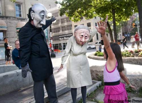 HADAS PARUSH / WINNIPEG FREE PRESS
Promoting their show, Grim and Fischer, Andrew Phoenix (left) and Kate Braidwood (centre) interact with Destiny Lavallee (right) at the Old Market Square.