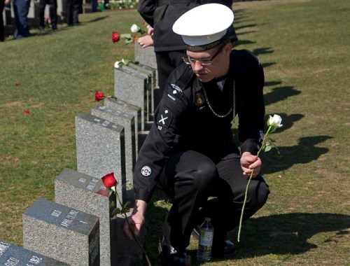 An air cadet places a flower on a grave marker at a memorial service at Fairview Lawn Cemetery to mark the 100th anniversary of the sinking of RMS Titanic in Halifax on Sunday, April 15, 2011. THE CANADIAN PRESS/Andrew Vaughan