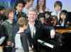 Stephen Harper smiles after playing piano with a group of children while visiting the Royal Conservatory of Music in Toronto in 2009. We reached out to the leaders of the four major federal parties to find out what songs are blasting out of their speakers on the campaign trail. Frank Gunn / The Canadian Press
