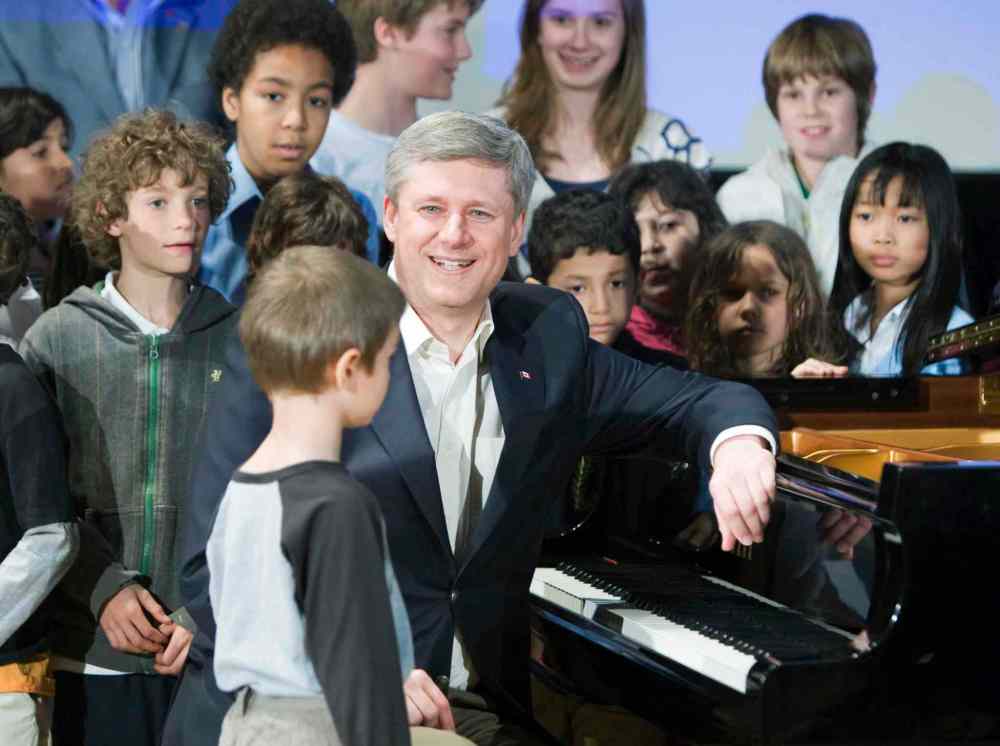 Stephen Harper smiles after playing piano with a group of children while visiting the Royal Conservatory of Music in Toronto in 2009. We reached out to the leaders of the four major federal parties to find out what songs are blasting out of their speakers on the campaign trail. Frank Gunn / The Canadian Press