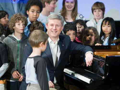Stephen Harper smiles after playing piano with a group of children while visiting the Royal Conservatory of Music in Toronto in 2009. We reached out to the leaders of the four major federal parties to find out what songs are blasting out of their speakers on the campaign trail. Frank Gunn / The Canadian Press