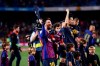 Barcelona forward Lionel Messi, left, and Barcelona midfielder Sergio Busquets, with their children, celebrate winning the Spanish League title, at the end of the Spanish La Liga soccer match between FC Barcelona and Levante at the Camp Nou stadium in Barcelona, Spain, Saturday, April 27, 2019. Barcelona clinched the Spanish La Liga title, with three matches to spare, after it defeated Levante 1-0. (AP Photo/Manu Fernandez)