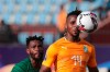 Ivory Coast's Jonathan Kodjia, right, goes for the ball past South Africa's Thulani Hlatshwayo during the African Cup of Nations group D soccer match between Ivory Coast and South Africa in Al Salam Stadium in Cairo, Egypt, Monday, June 24, 2019. (AP Photo/Hassan Ammar)