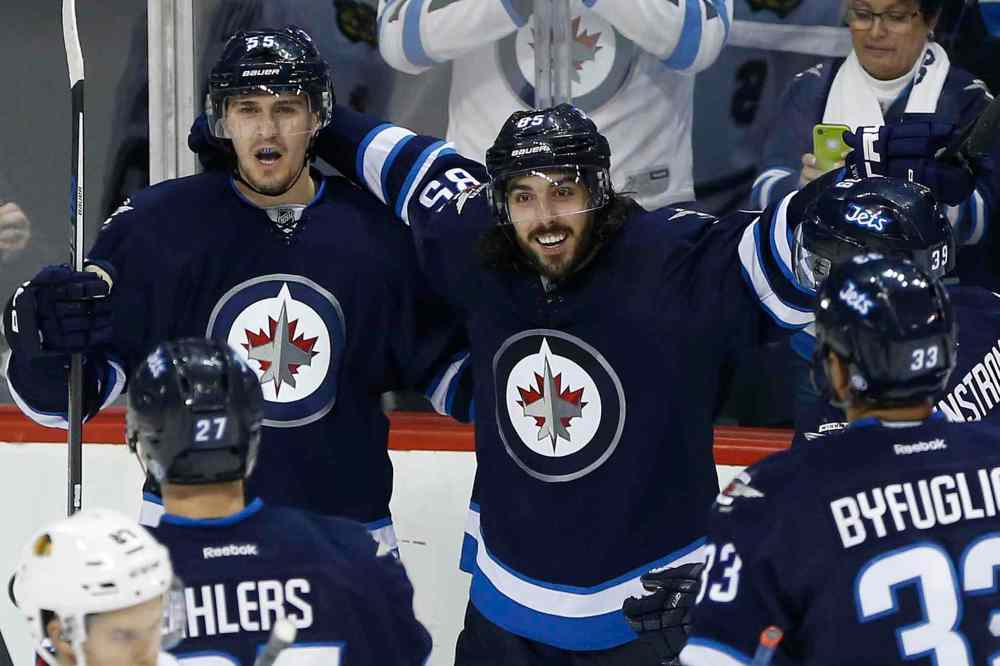 CP
Winnipeg Jets' Mark Scheifele (55) and Mathieu Perreault (85) celebrate Scheifele's goal on Chicago Blackhawks goaltender Corey Crawford (50) during third period NHL action in Winnipeg on Thursday, October 29, 2015. THE CANADIAN PRESS/John Woods