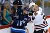 John Woods / The Canadian Press
Chicago Blackhawks' Michal Rozsival (32) loses his helmet after a hit from Winnipeg Jets' Mathieu Perreault (85) during first period NHL action in Winnipeg on Friday.