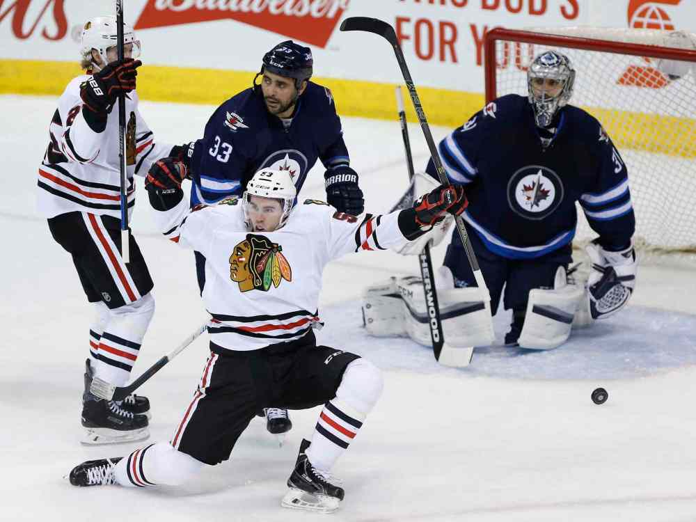 JOHN WOODS / THE CANADIAN PRESS
Chicago's Brandon Mashinter (53) and Dale Weise (25) celebrate Mashinter's goal against Winnipeg goaltender Ondrej Pavelec.