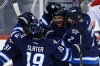 JOHN WOODS / The Canadian Press
Winnipeg Jets' Jiri Tlusty (91), Jim Slater (19), Dustin Byfuglien (33) and Adam Pardy (2) celebrate Byfuglien's goal against Montreal Canadiens goaltender Dustin Tokarski (35) during first period NHL action in Winnipeg on Thursday.