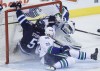 JOHN WOODS / THE CANADIAN PRESS
Winnipeg Jets' Mark Stuart (5) and Vancouver Canucks' Alexander Edler (23) crash into Canucks goaltender Eddie Lack (31).